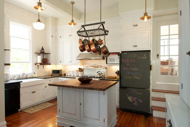 Elegant u-shaped enclosed kitchen photo in San Francisco with flat-panel cabinets, white cabinets, white backsplash and subway tile backsplash