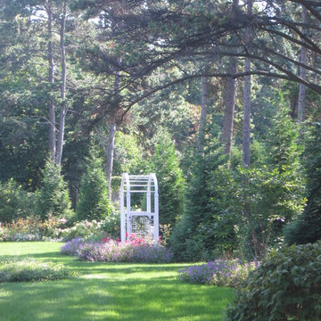 Roses and catmint flank the garden seat