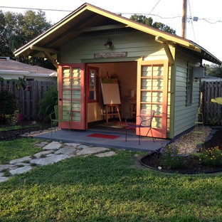 This is an example of a small traditional home studio in Tampa with no fireplace, a freestanding desk, white walls, concrete floors and black floor.