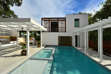 Inspiration for a mid-sized contemporary outdoor kitchen deck remodel in Tampa with a pergola