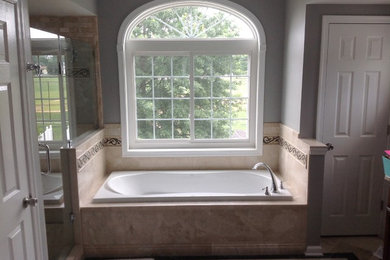 Example of a mid-sized classic master beige tile and ceramic tile ceramic tile and beige floor bathroom design in Philadelphia with gray walls and a hinged shower door