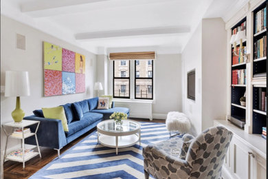 Inspiration for a mid-sized transitional enclosed dark wood floor and brown floor living room library remodel in New York with gray walls, a wall-mounted tv and no fireplace