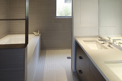Photo of a modern master bathroom in San Francisco with an undermount sink, flat-panel cabinets, dark wood cabinets, an open shower, beige tile, ceramic tile, grey walls, an undermount tub and an open shower.