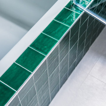 Vibrant Green Ceramic Tiles Bring Life to a Hallway Bathroom