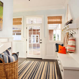 Ispirazione per un grande ingresso con anticamera costiero con pareti blu, una porta singola, una porta in vetro e parquet scuro