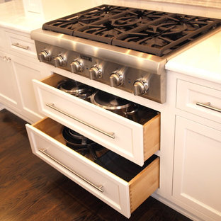 Large traditional kitchen pantry inspiration - Inspiration for a large timeless u-shaped dark wood floor and brown floor kitchen pantry remodel in Newark with a drop-in sink, beaded inset cabinets, white cabinets, beige backsplash, stainless steel appliances and an island