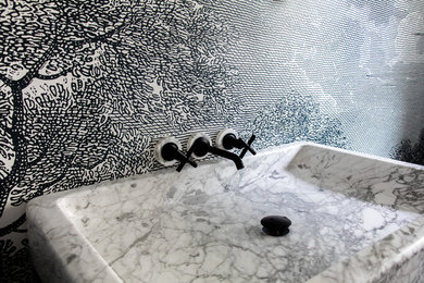 Inspiration for a small contemporary 3/4 marble floor and multicolored floor bathroom remodel in Cleveland with black walls, an integrated sink and marble countertops