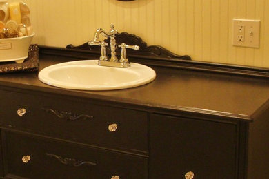 Mid-sized elegant master linoleum floor claw-foot bathtub photo in Other with dark wood cabinets, wood countertops and beige walls