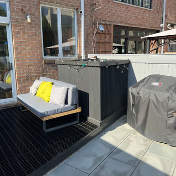 Paved patio with metal grating garden