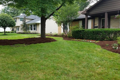 Photo of a large traditional full sun front yard gravel formal garden in Cleveland.