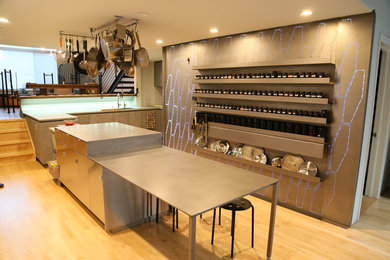 Inspiration for a contemporary l-shaped light wood floor and beige floor eat-in kitchen remodel in San Francisco with an undermount sink, flat-panel cabinets, gray cabinets, gray backsplash, metal backsplash, paneled appliances, an island and gray countertops