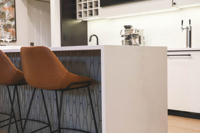 Inspiration for a contemporary galley seated home bar in Other with an undermount sink, flat-panel cabinets, white cabinets, quartz benchtops, white splashback, mosaic tile splashback and white benchtop.