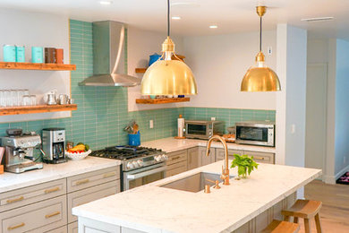 Inspiration for a mid-sized modern laminate floor kitchen remodel in Los Angeles with a single-bowl sink, raised-panel cabinets, gray cabinets, glass tile backsplash and an island
