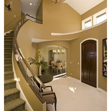 Foyer with Curved Staircase White Oak and Stainless Steel Handrails
