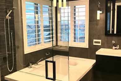 Inspiration for a mid-sized contemporary master black tile and porcelain tile porcelain tile and gray floor corner shower remodel in Salt Lake City with furniture-like cabinets, black cabinets, an undermount tub, a wall-mount toilet, gray walls, an undermount sink, a hinged shower door and quartz countertops
