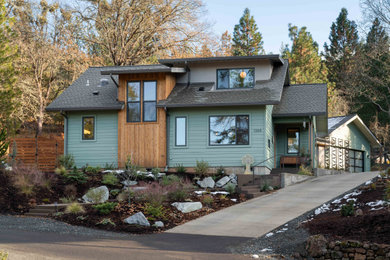 Example of a mid-sized multicolored two-story mixed siding exterior home design in Other with a shingle roof
