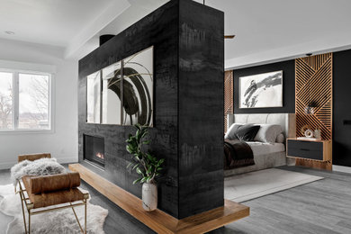 Inspiration for a large modern master gray floor and wall paneling bedroom remodel in Denver with a tile fireplace