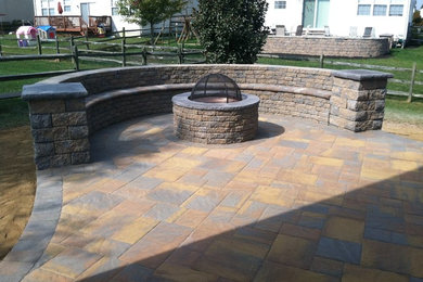 Design ideas for a mid-sized country backyard patio in Wilmington with a fire feature and concrete pavers.