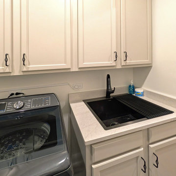 Panoramic Penthouse: Laundry Room with Dark Washer and Built-in Sink