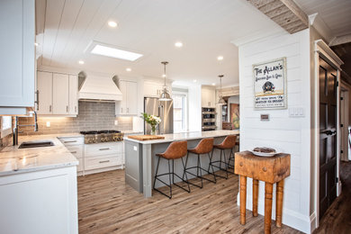 Inspiration for a large contemporary l-shaped vinyl floor, brown floor and shiplap ceiling eat-in kitchen remodel in Other with a double-bowl sink, white cabinets, quartzite countertops, gray backsplash, porcelain backsplash, stainless steel appliances, an island and white countertops