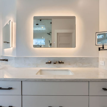 Modern Spa-Inspired Primary Bathroom with Custom Lighting and Views