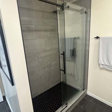 Large-Format Marble Shower & Dark Vanity Bathroom