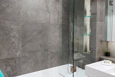 Inspiration for a modern master bathroom in Sydney with an alcove tub, a shower/bathtub combo, porcelain tile, a wall-mount sink, a hinged shower door, a niche and a single vanity.
