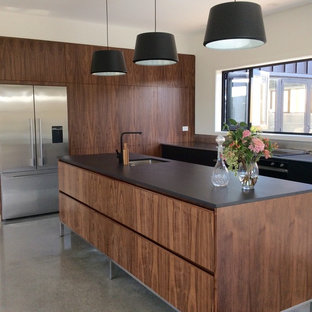 Mid-sized modern kitchen pantry ideas - Inspiration for a mid-sized modern l-shaped concrete floor kitchen pantry remodel in Other with a single-bowl sink, black cabinets, stainless steel countertops and an island