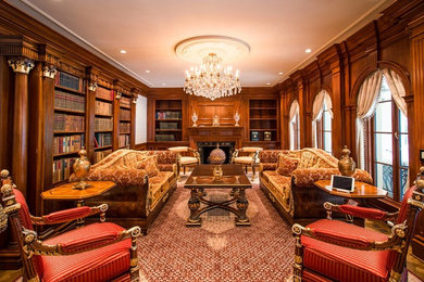 Study room - mid-sized freestanding desk medium tone wood floor study room idea in DC Metro with brown walls, a standard fireplace and a stone fireplace