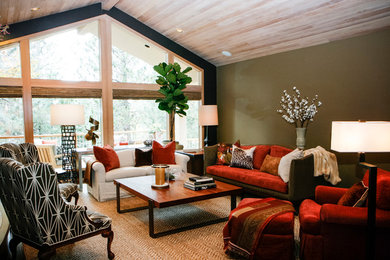 Large transitional open concept medium tone wood floor living room photo in Other with green walls and a standard fireplace