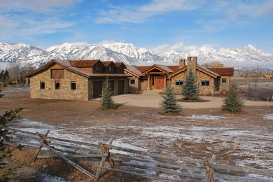 Inspiration for a large craftsman brown two-story stone exterior home remodel in Other with a shingle roof