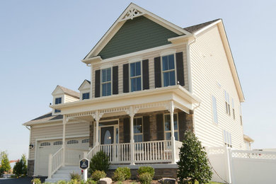 Inspiration for a timeless beige two-story mixed siding exterior home remodel in DC Metro