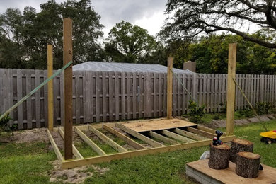 Farmhouse backyard patio photo in Tampa with decking and a pergola