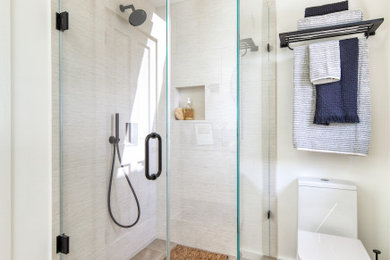 Inspiration for a mid-sized contemporary kids' beige tile and ceramic tile porcelain tile, brown floor and single-sink corner shower remodel in San Francisco with flat-panel cabinets, beige cabinets, a one-piece toilet, white walls, an undermount sink, quartz countertops, a hinged shower door, brown countertops, a niche and a floating vanity