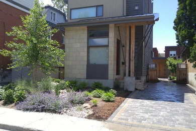 Design ideas for a small modern front yard partial sun xeriscape for summer in Ottawa with concrete pavers.