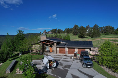 Large minimalist one-story house exterior photo in Other with a brown roof and a shingle roof