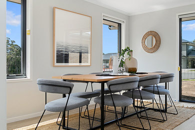Inspiration for a mid-sized contemporary open plan dining in Hobart with grey walls, laminate floors and grey floor.