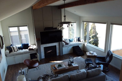 Large transitional open concept dark wood floor and brown floor family room photo in Other with white walls, a standard fireplace, a stone fireplace and a wall-mounted tv