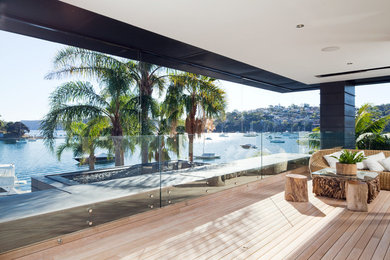 Inspiration for a contemporary front yard verandah in Sydney with decking and a roof extension.