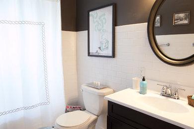 This is an example of a traditional bathroom in Omaha with subway tile, black walls and black and white tile.
