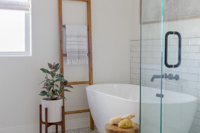 Inspiration for a mid-sized transitional master white tile and ceramic tile porcelain tile, multicolored floor, double-sink and wood wall bathroom remodel in San Diego with gray cabinets, a two-piece toilet, white walls, an undermount sink, quartz countertops, a hinged shower door, white countertops and a built-in vanity