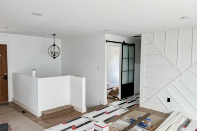 Single front door - mid-sized modern laminate floor and multicolored floor single front door idea in Baltimore with white walls and a dark wood front door