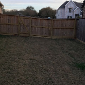 Install boards at the bottom of cedar fence to help keep owners dog in the yard.