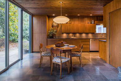 Large 1960s ceramic tile, gray floor, wood ceiling and wood wall kitchen/dining room combo photo in Portland