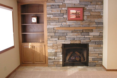 Living room - mid-sized enclosed carpeted living room idea in Minneapolis with beige walls, a standard fireplace and a stone fireplace