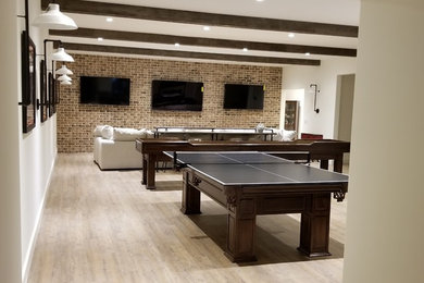Example of a large classic underground light wood floor and brown floor basement design in Atlanta with white walls