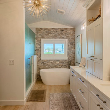Coastal Bathroom with Freestanding Tub and Stacked Stone Wall