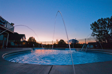 Example of a large classic backyard kidney-shaped and concrete paver natural pool fountain design in New York