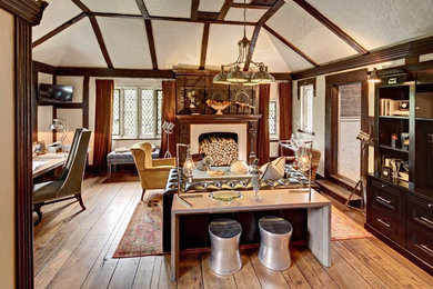 Inspiration for a mid-sized eclectic open concept medium tone wood floor living room remodel in New York with white walls and no fireplace