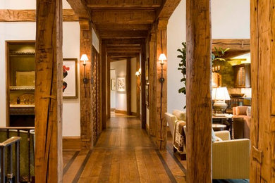 Inspiration for a huge rustic dark wood floor hallway remodel in Denver with white walls